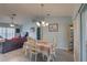 Bright dining room featuring a table with four chairs and laminate flooring at 11463 Cavern Rd, Spring Hill, FL 34609