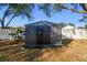 Black metal storage shed in backyard at 11528 Andy Dr, Riverview, FL 33569