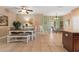 Dining room with a wooden table, bench seating, and access to the kitchen at 11849 Colony Lakes Blvd, New Port Richey, FL 34654