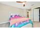 Charming bedroom with a twin-size bed, dresser, and ceiling fan at 12062 Nouveau Ave, Spring Hill, FL 34610