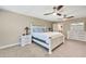 Spacious main bedroom with large bed, two ceiling fans, and ensuite bathroom access at 12062 Nouveau Ave, Spring Hill, FL 34610