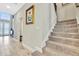 Elegant staircase with carpeted steps and a view of the entryway at 12062 Nouveau Ave, Spring Hill, FL 34610