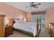 Main bedroom with wood furniture and sliding door access at 12133 Spartan Way # 203, Hudson, FL 34667