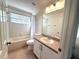 Cozy bathroom with single sink vanity and shower-tub combination at 12336 Southbridge Ter, Hudson, FL 34669