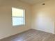 Bright bedroom featuring new wood-look floors and neutral decor at 12336 Southbridge Ter, Hudson, FL 34669