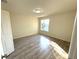 Bright bedroom features wood-look floors and a window providing natural light at 12336 Southbridge Ter, Hudson, FL 34669