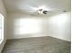 Spacious bedroom with new wood-look floors, ceiling fan, and neutral paint at 12336 Southbridge Ter, Hudson, FL 34669