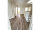 Bright upstairs hallway with wood flooring and white doors leads to the various bedrooms and bathrooms at 12336 Southbridge Ter, Hudson, FL 34669