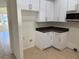 Bright kitchen features white cabinets, stainless steel microwave, and brown granite countertops at 12336 Southbridge Ter, Hudson, FL 34669