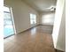 Open living room with tile and wood flooring and sliding door to the outside at 12336 Southbridge Ter, Hudson, FL 34669