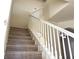 The staircase features white wood trim and wood-look laminate stairs at 12336 Southbridge Ter, Hudson, FL 34669
