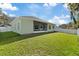 House with large backyard, screened patio, and grassy area at 12739 Balsam Ave, Hudson, FL 34669