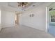 Bright bedroom with ceiling fan and access to patio at 12739 Balsam Ave, Hudson, FL 34669