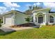 Single-story house with a light green exterior and attached garage at 12739 Balsam Ave, Hudson, FL 34669