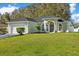 Single-story house with a light green exterior and attached garage at 12739 Balsam Ave, Hudson, FL 34669