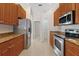 Modern kitchen with stainless steel appliances and granite countertops at 12739 Balsam Ave, Hudson, FL 34669