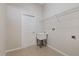 Bright laundry room featuring a utility sink, shelving, and tile flooring at 12739 Balsam Ave, Hudson, FL 34669
