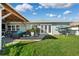 Spacious backyard with green grass, patio, and kayak storage at 13610 Evelane Dr, Hudson, FL 34667
