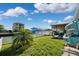 Large grassy backyard with a view of the canal and boats at 13610 Evelane Dr, Hudson, FL 34667