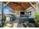 Relaxing covered patio with seating, fire pit, and ceiling fan at 13610 Evelane Dr, Hudson, FL 34667