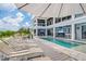 Relaxing poolside view with lounge chairs and patio umbrella at 16176 La Barge Cir, Port Charlotte, FL 33981