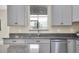 Kitchen with gray cabinets, granite countertops, and stainless steel sink at 3066 Hover Hall Ln, New Port Richey, FL 34655