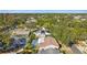 A sprawling neighborhood is captured, dotted with mature trees and featuring residences with screened pools at 465 Meadowlark Ln, Palm Harbor, FL 34683