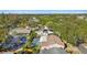 A sprawling neighborhood is captured, dotted with mature trees and featuring residences with screened pools at 465 Meadowlark Ln, Palm Harbor, FL 34683
