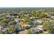 A sprawling neighborhood is captured, dotted with mature trees and featuring residences with screened pools at 465 Meadowlark Ln, Palm Harbor, FL 34683