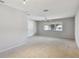 Spacious bedroom with a ceiling fan, closet, and a window with a tree visible outside at 465 Meadowlark Ln, Palm Harbor, FL 34683