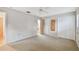 Neutral bedroom with carpeting, closet space, ceiling fan, and natural light at 465 Meadowlark Ln, Palm Harbor, FL 34683