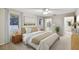 Bedroom featuring neutral carpet, ensuite bath, walk-in closet, and ample natural light at 465 Meadowlark Ln, Palm Harbor, FL 34683