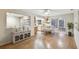 Open dining area with hardwood floors, a sideboard, and a view into the kitchen with white appliances at 465 Meadowlark Ln, Palm Harbor, FL 34683
