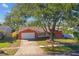 Charming single-story home showcasing a well-maintained yard and classic architectural details at 465 Meadowlark Ln, Palm Harbor, FL 34683