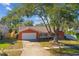 Charming single-story home showcasing a well-maintained yard and classic architectural details at 465 Meadowlark Ln, Palm Harbor, FL 34683