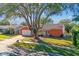 Charming single-story home showcasing a well-maintained yard and classic architectural details at 465 Meadowlark Ln, Palm Harbor, FL 34683