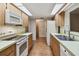 Eat-in kitchen featuring wood cabinets, white appliances, and a view to Gathering room at 465 Meadowlark Ln, Palm Harbor, FL 34683