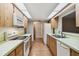 Eat-in kitchen with wood cabinets and white appliances at 465 Meadowlark Ln, Palm Harbor, FL 34683
