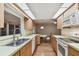 Kitchen features wood cabinets, stainless steel sink, and views to Gathering room at 465 Meadowlark Ln, Palm Harbor, FL 34683