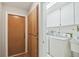 Laundry room with a washer, dryer, utility sink, and storage at 465 Meadowlark Ln, Palm Harbor, FL 34683