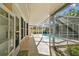 Screened patio with ample space for seating, overlooks the pool area at 465 Meadowlark Ln, Palm Harbor, FL 34683