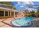 A screened-in pool in a lush backyard, creating a private oasis at 465 Meadowlark Ln, Palm Harbor, FL 34683