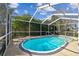 Refreshing kidney-shaped pool in a screened enclosure at 465 Meadowlark Ln, Palm Harbor, FL 34683