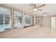 Spacious sunroom with tiled floors offers a screened pool view through large windows at 465 Meadowlark Ln, Palm Harbor, FL 34683