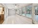 Bright and airy sunroom with neutral colors and a view of the screened pool at 465 Meadowlark Ln, Palm Harbor, FL 34683