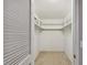 Walk-in closet featuring white paint, carpet flooring, and ample shelving at 465 Meadowlark Ln, Palm Harbor, FL 34683