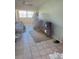 Bright living room with tile floors and large screen TV at 4901 Onyx Ln # 202, New Port Richey, FL 34652