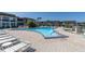Community pool with lounge chairs and brick pavers at 4901 Onyx Ln # 202, New Port Richey, FL 34652