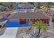 Aerial view of a red house with a large yard and palm tree at 5200 Quintilis St, Spring Hill, FL 34608