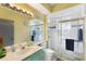 Clean bathroom with shower, toilet and light teal vanity at 5211 Karlsburg Pl, Palm Harbor, FL 34685